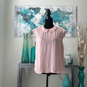 Pink shirt with caped sleeves and a buttoning back with collar detail. POPSUGAR.